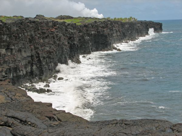 Coastline with lava steam cloud in background